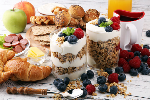 Breakfast served with coffee, orange juice, bread, parfaits and fruits. Balanced diet