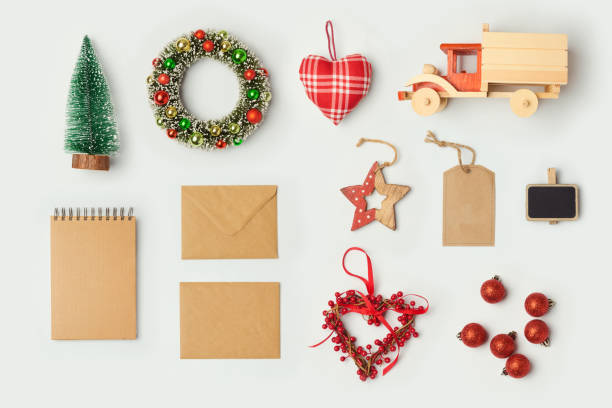 istock Christmas decorations and objects for mock up template design. Notebook, toy truck and wreath. View from above. Flat lay 868015206