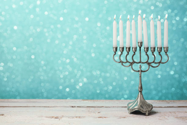 istock Menorah with candles for Hanukkah celebration over bokeh background 868015210