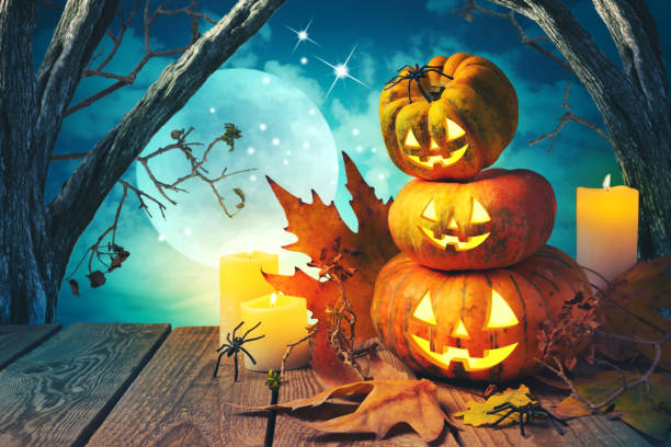 istock Halloween background with pumpkin jack o lantern over spooky trees 868015402