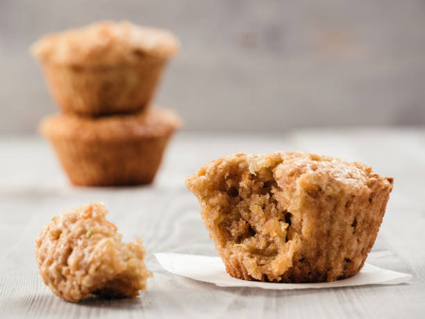 Muffins with zucchini, carrots, apple and cinnamon Close up view of muffin with zucchini, carrots, apple and cinnamon on gray wooden background. Sweet vegetables homemade muffins. Toddler-friendly recipe idea. Copy space. Shallow DOF muffin stock pictures, royalty-free photos & images