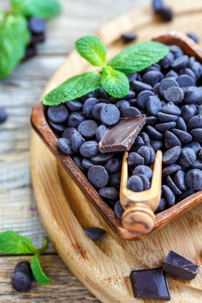 istock Scoop in wooden bowl with a black chocolate. 868029524