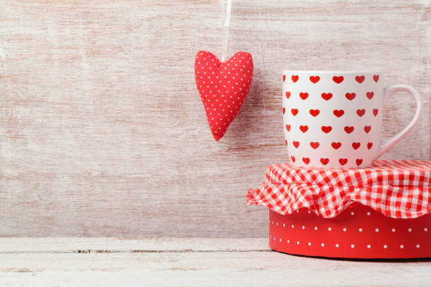 istock Valentine's day background with coffee cup and heart shape on wooden table 868033426