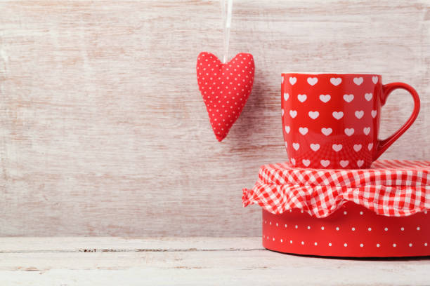 istock Valentine's day background with coffee cup and heart shape on wooden table 868033498