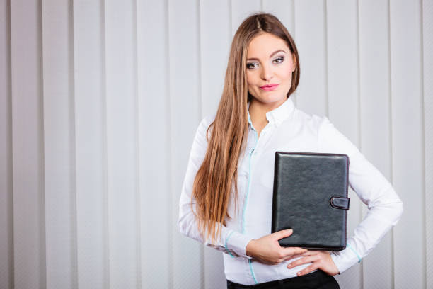 istock Young woman office worker hold case with files. 868034144