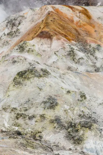 Photo of Close up detail of Noboribetsu Jigokudani (Hell Valley): The volcano valley got its name from the sulfuric smell, extremely high heat and steam spouting out of the ground in Hokkaido, Japan.