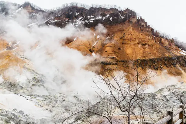 Photo of Noboribetsu Jigokudani (Hell Valley): The volcano valley got its name from the sulfuric smell, extremely high heat and steam spouting out of the ground in Hokkaido, Japan.