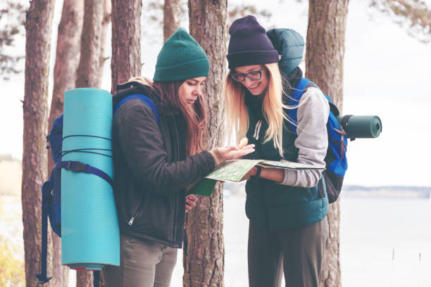 istock Two young tourist determine the route map and compass. 868043758