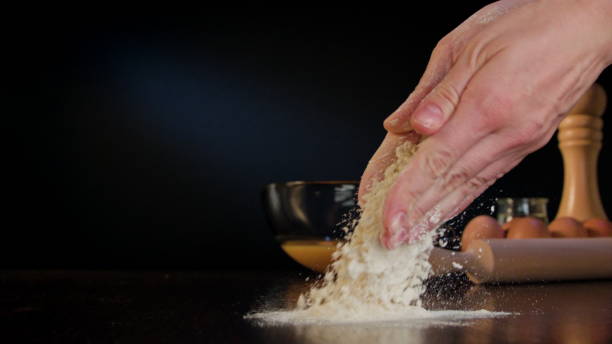 istock Female Hands Spilling Flour on the Table 868043882