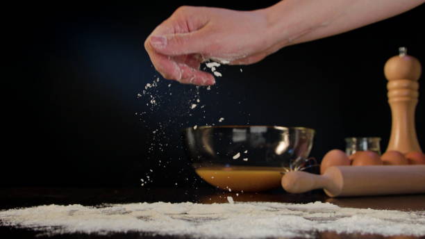 istock Female Hand Spreading Flour on the Table 868043964
