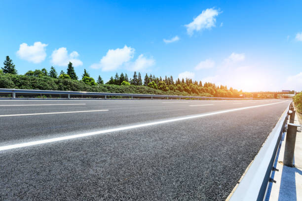 istock asphalt road and green tree landscape at dusk 868048916