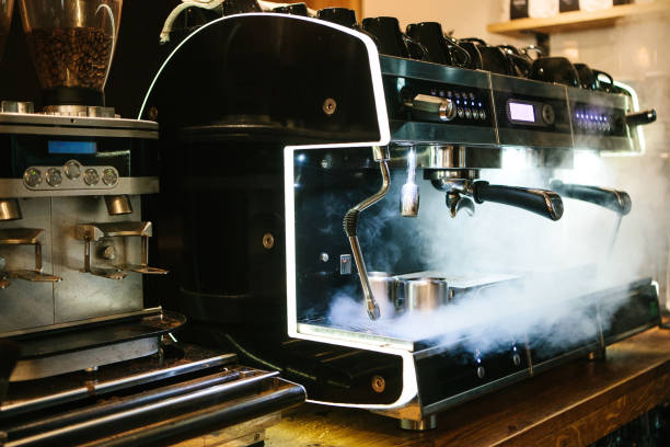 Coffee machine with steam in the process. A cafe Coffee machine with steam in the process. espresso maker stock pictures, royalty-free photos & images
