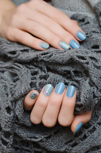 istock Beautiful female hand with blue nail design 868053758