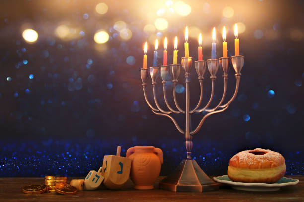istock image of spinnig top, menorah (traditional candelabra) and burning candles 868054608