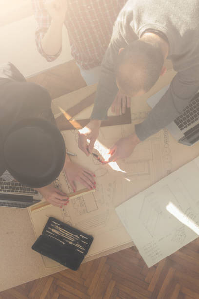 istock Group of young people / architects being creative in a small office. 868054786