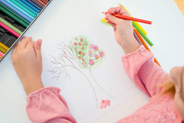 istock High Angle View Of Young Girl Drawing Tree On White Paper 868057084