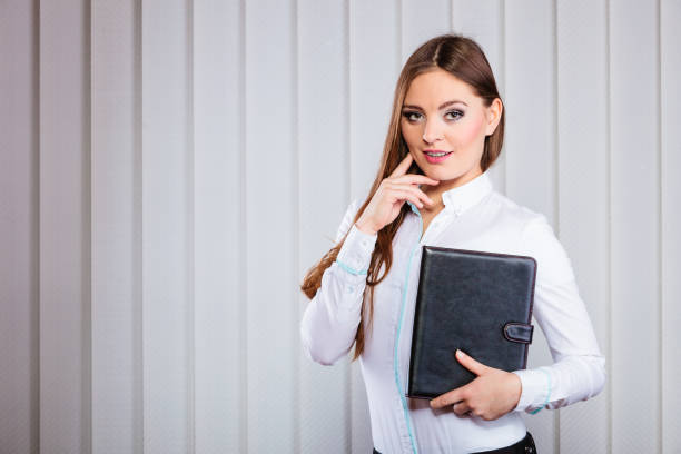 istock Young woman office worker hold case with files. 868057110