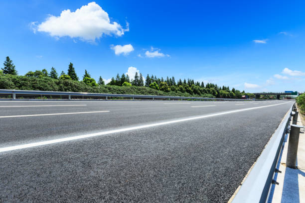 istock asphalt road and green forest under the blue sky 868057248