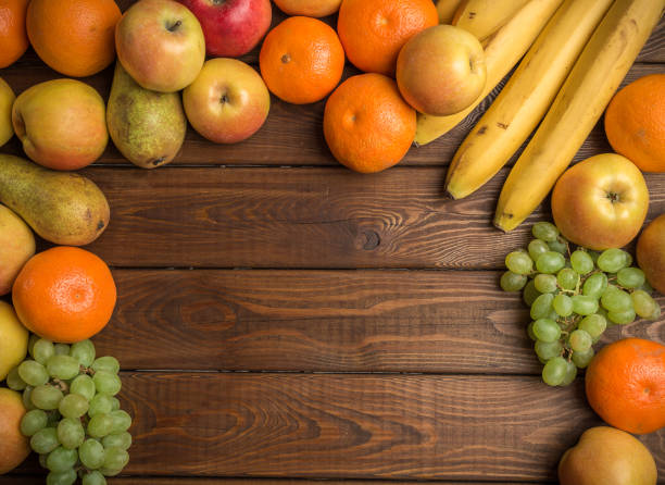istock Fresh organic fruits on rustic wooden background 868057520