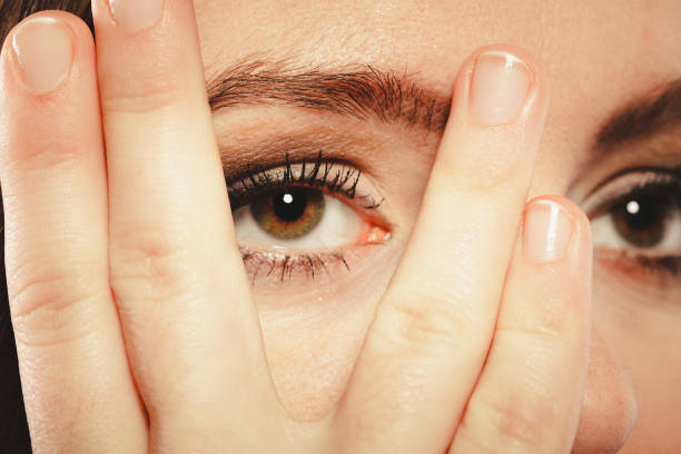 istock Woman cover face look through fingers. 868057668
