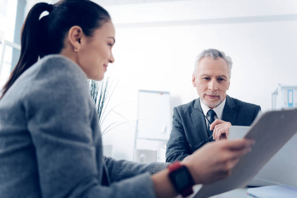 istock Selective focus on positive chief looking at business document 868060814