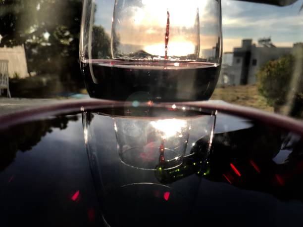 Glasses of red wine with reflection of outdoors