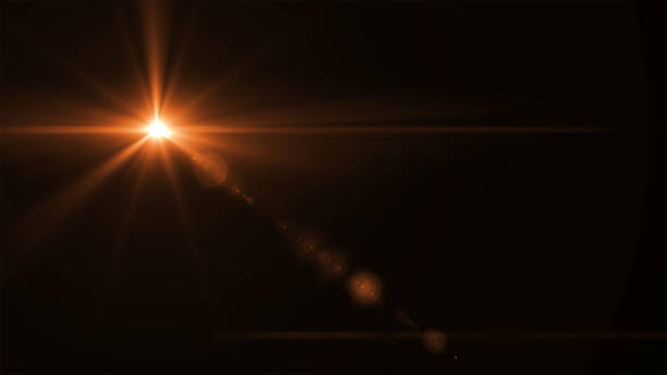 abstract sun burst with digital lens flare light over black background stock photo
