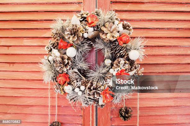 Christmas Wreath Hanging On Wooden Blinds Stock Photo - Download Image Now - Adult, Black Color, Building Entrance