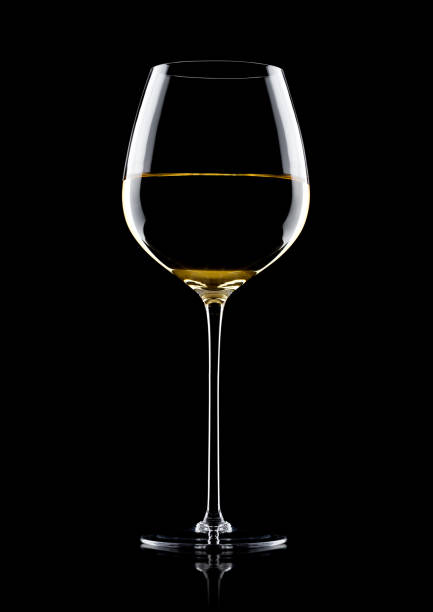 istock Glass of white wine with reflection on black 868070946