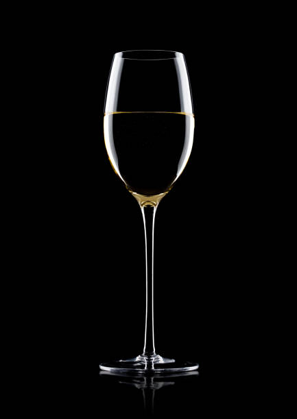 istock Glass of white wine with reflection on black 868070984