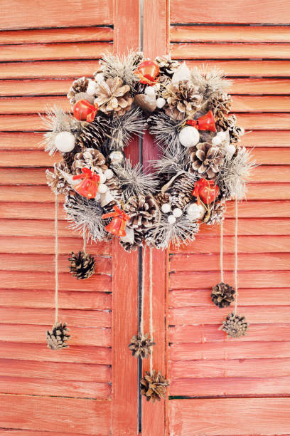 istock Christmas wreath hanging on wooden blinds 868071100