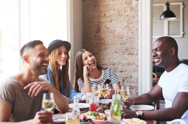 istock Four friends having fun and eating together 868071226