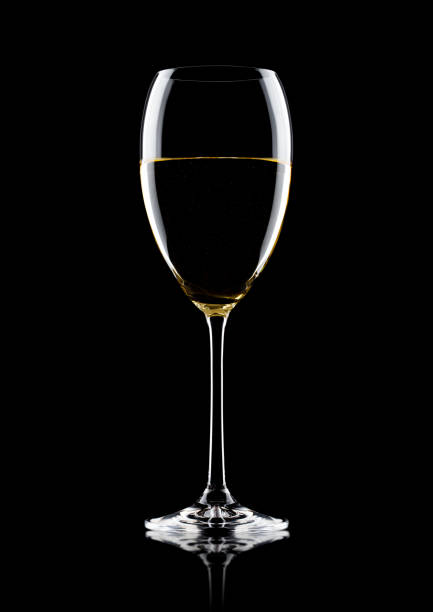 istock Glass of white wine with reflection on black 868071410