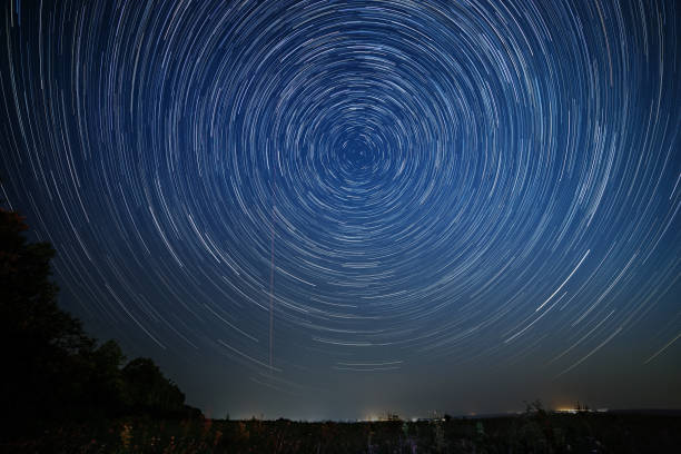 istock Night sky with bright stars trails. Astrophotography of outer space. 868071446