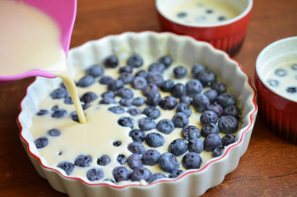 istock Pouring clafoutis dough in a baking tray 868071956