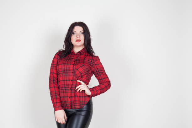 istock fat girl in a red shirt posing in the Studio 868079956