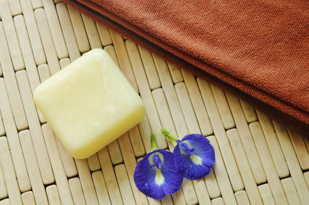 soap and towel with blue pea on bamboo mat