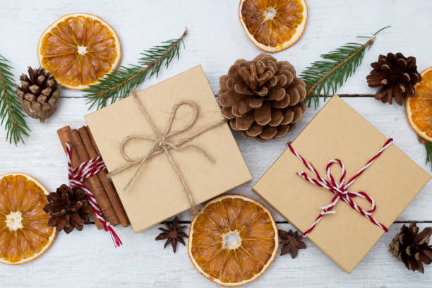 istock Two gift boxes on a wooden background and Christmas decorations. Flat lay 868091542