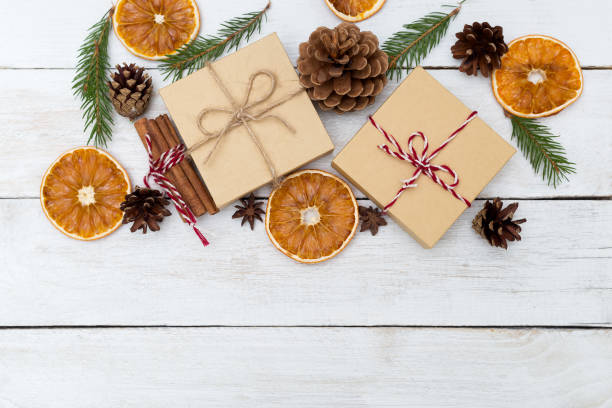 istock Christmas composition. Christmas gift, pine cones, fir branches on wooden white background 868091554