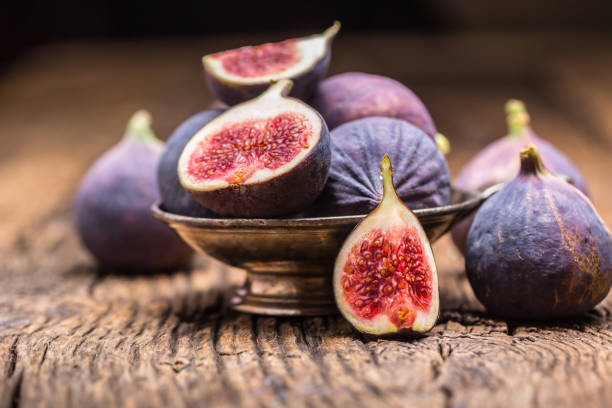 istock Figs. A few figs in a bowl on an old wooden background 868094124