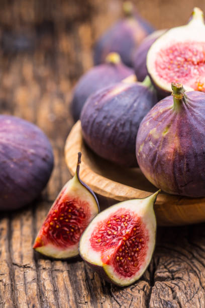 istock Figs. A few figs in a bowl on an old wooden background 868094144