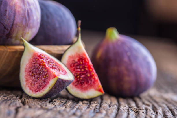 istock Figs. A few figs in a bowl on an old wooden background 868094152