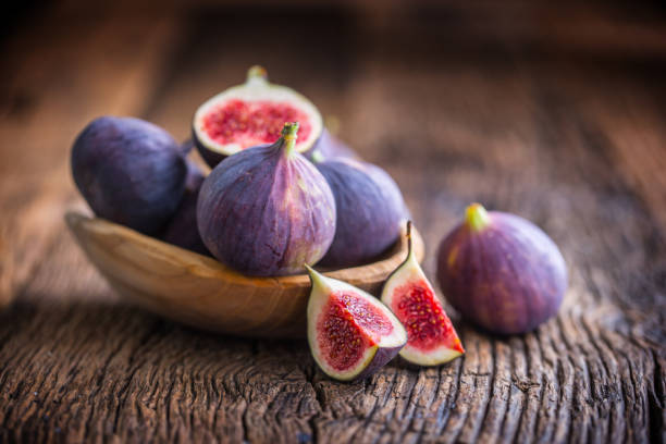 istock Figs. A few figs in a bowl on an old wooden background 868094154