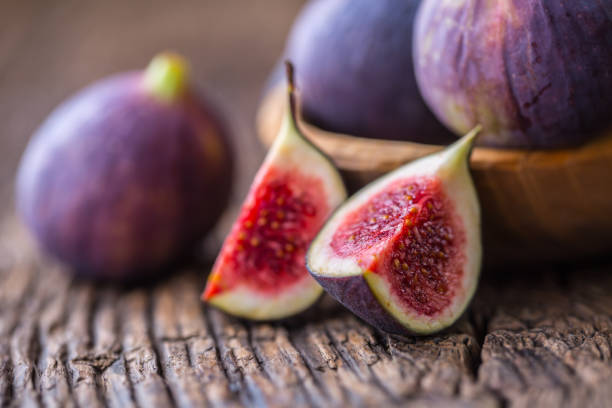 istock Figs. A few figs in a bowl on an old wooden background 868094156