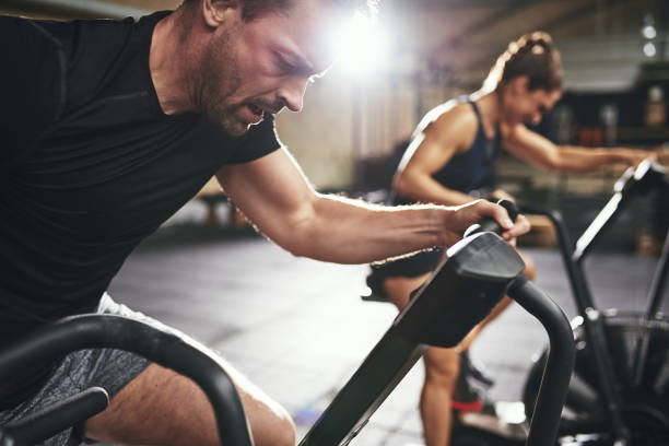istock Two people in hard efforts riding simulators 868094370