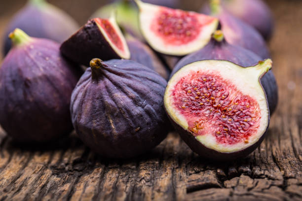 istock Figs. A few figs in a bowl on an old wooden background 868094594