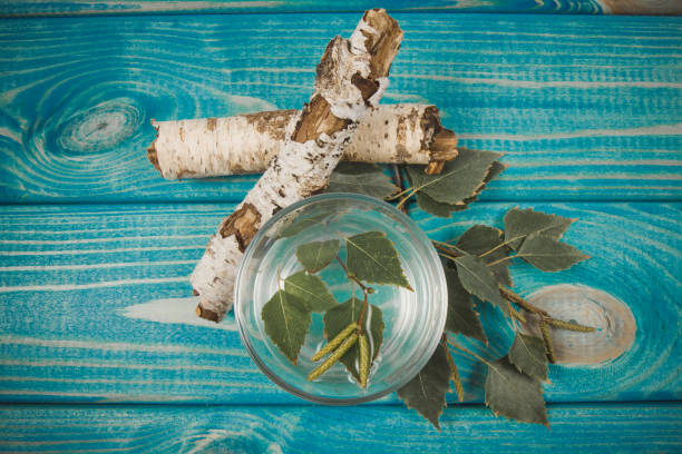 A glass of birch juice on wooden background stock photo