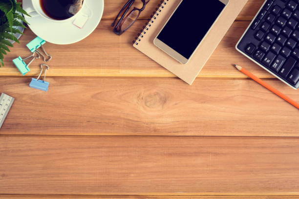 istock top view desk wood and office equipment 868098660