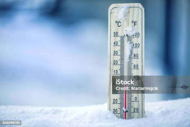 Thermometer On Snow Shows Low Temperatures Zero Low Temperatures In Degrees Celsius And Fahrenheit Cold Winter Weather Zero Celsius Thirty Two Farenheit Stock Photo - Download Image Now