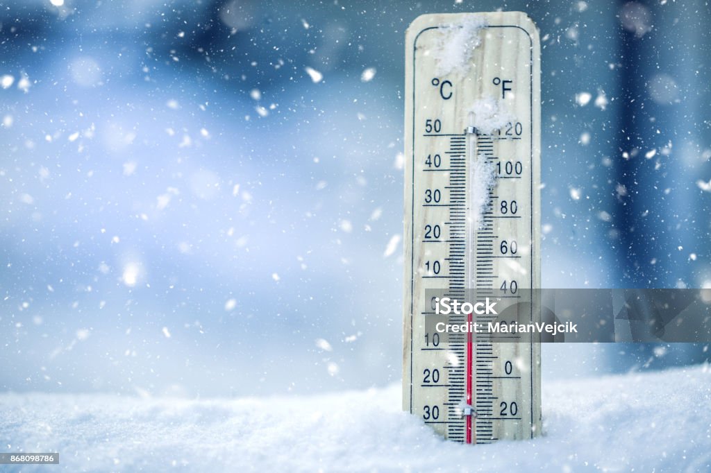 Thermometer on snow shows low temperatures - zero. Low temperatures in degrees Celsius and fahrenheit. Cold winter weather - zero celsius thirty two farenheit Thermometer on snow shows low temperatures - zero. Low temperatures in degrees Celsius and fahrenheit. Cold winter weather - zero celsius thirty two farenheit. Cold Temperature Stock Photo